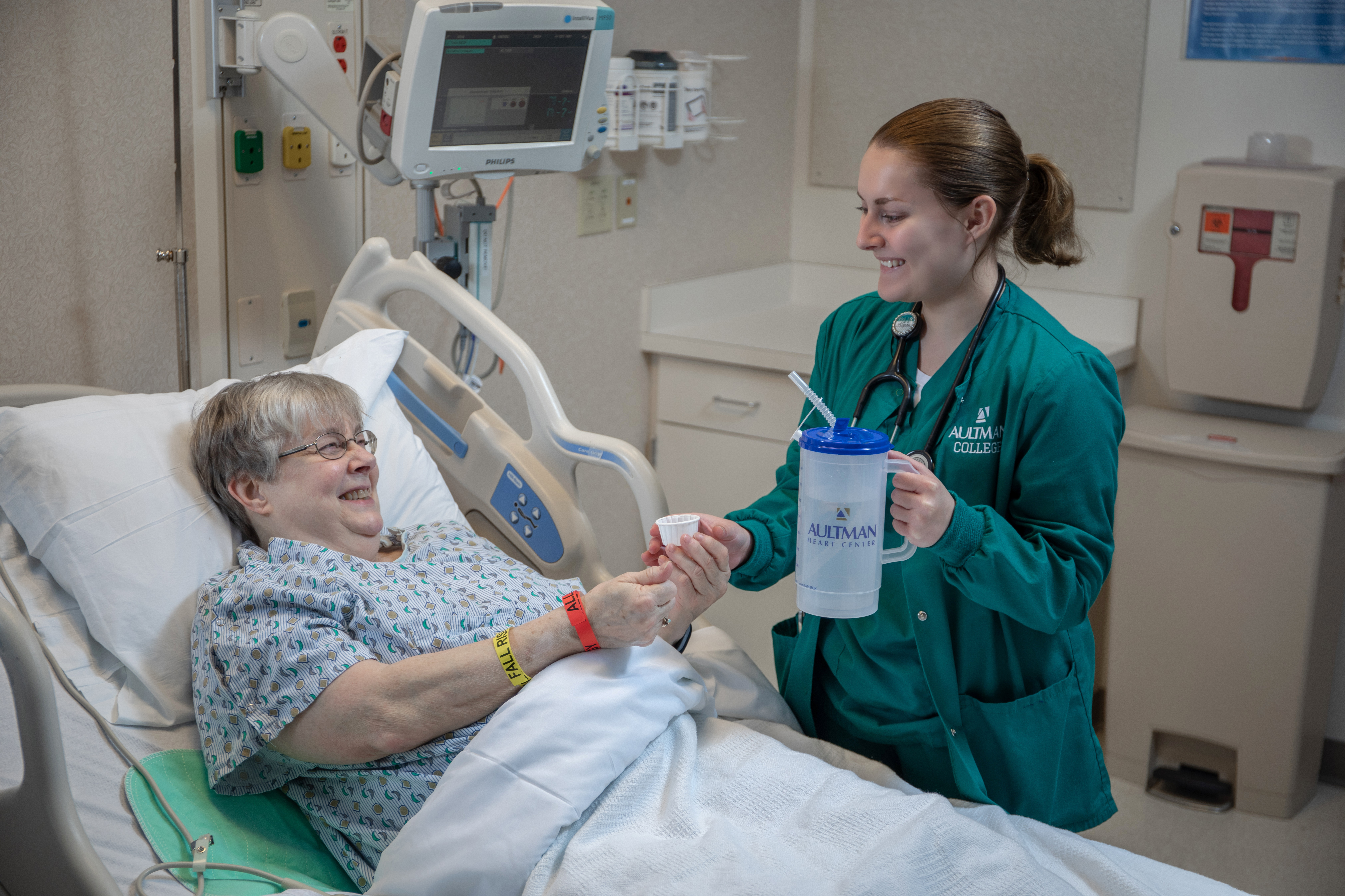RN nursing program student interacts with a patient during training